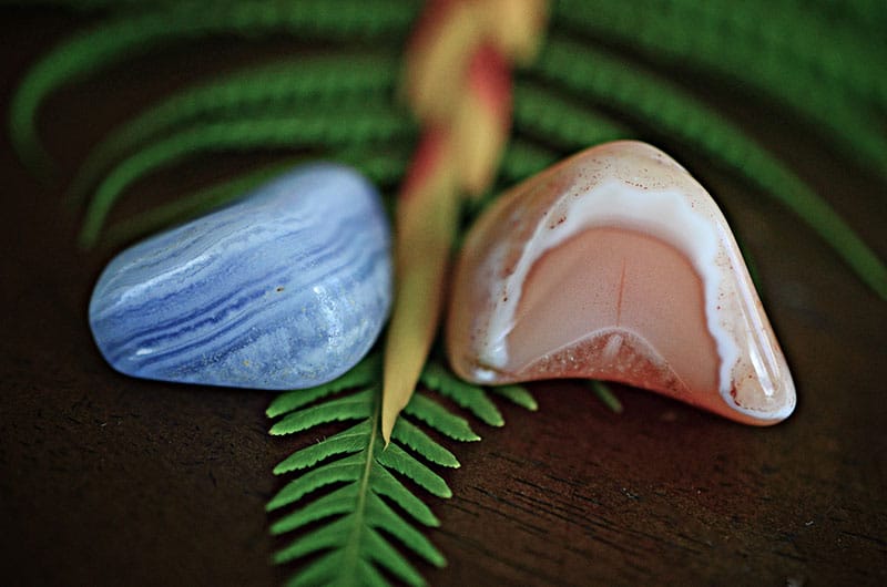 Tumbled stones of blue lace agate and rhodochrosite.