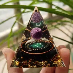 Leo orgonite pyramid with amethyst sphere, black tourmaline, and gold leaf.