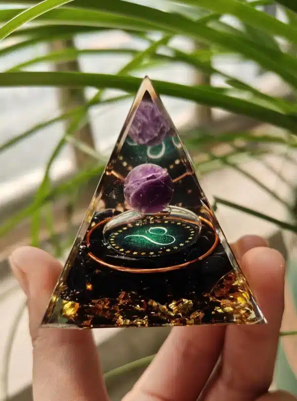Leo orgonite pyramid with amethyst sphere, black tourmaline, and gold leaf.
